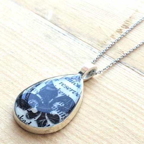 Fleur de Lis Teardrop Pendant Necklace by Emily McDonald | Silver plated copper, epoxy resin, magazine paper, cookbook page, stainless steel chain Fleur de Lis Teardrop Pendant Necklace