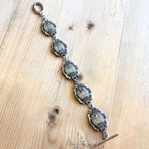 Life & Love Sheet Music Bracelet by Emily McDonald | Silver plated copper, sheet music, epoxy resin Life & Love Sheet Music Bracelet