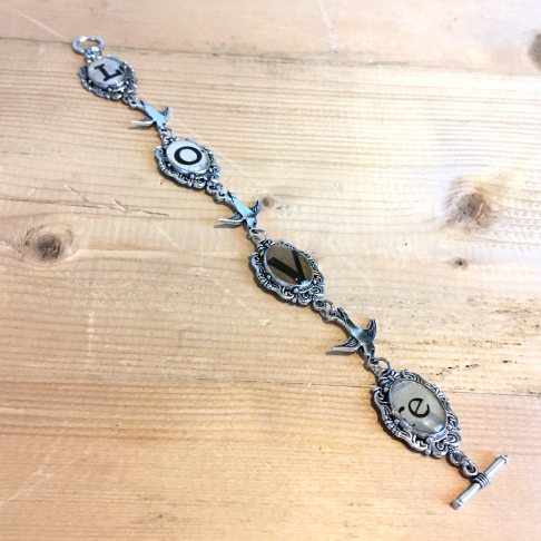 Love Bird Bracelet by Emily McDonald | Silver plated copper, vintage sheet music, epoxy resin Love Bird Bracelet